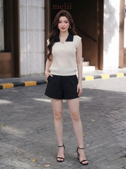 MELII ivory and black contrast-collar knit top with zip neckline, closer lifestyle view