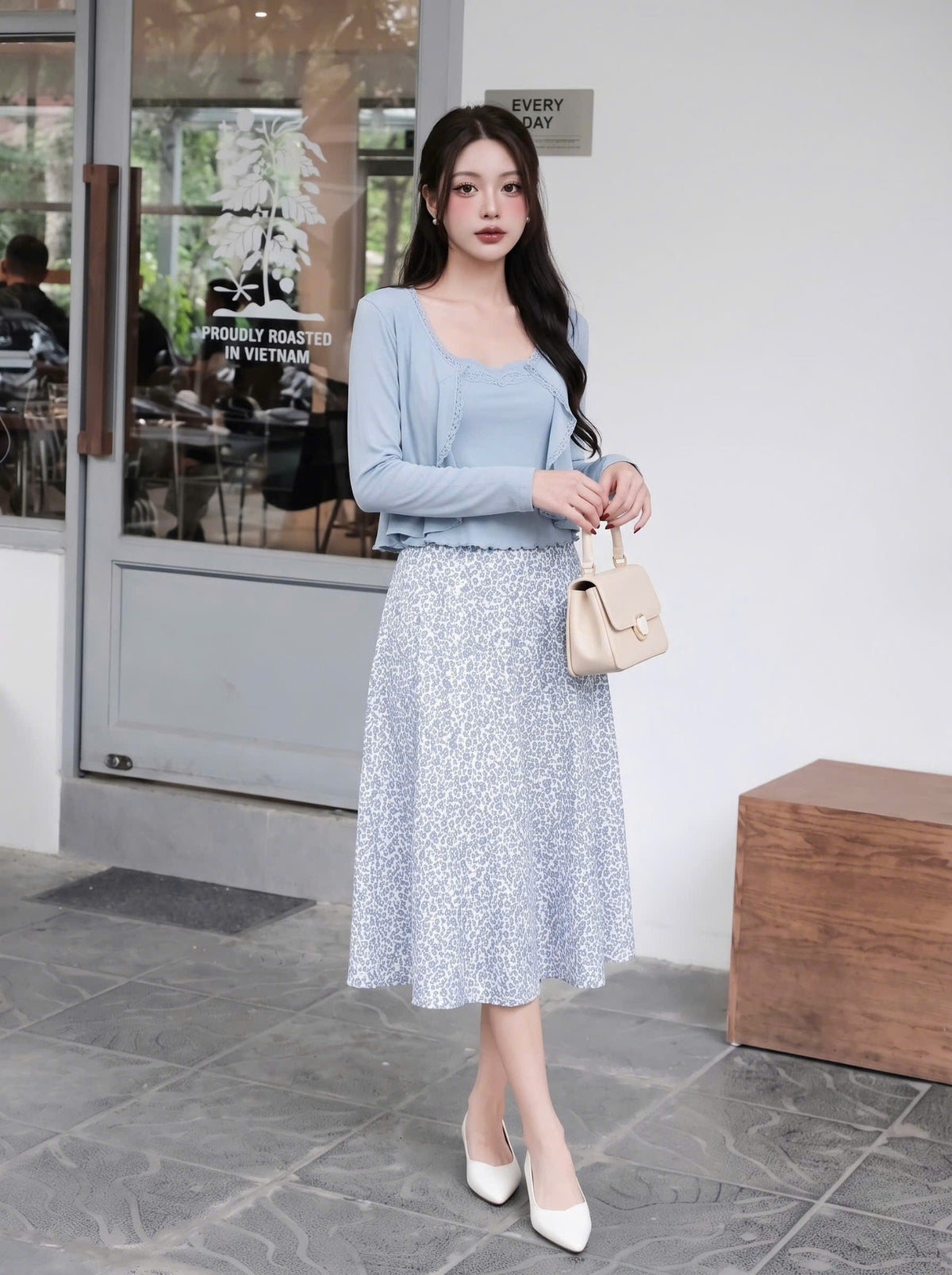 Adeline Three-Piece Cardigan Set in Powder Blue, standing café view