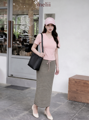 MELII Mira Blush Pink V-Neck Top and Striped Maxi Skirt Set, alternate on-model view outside a cafe