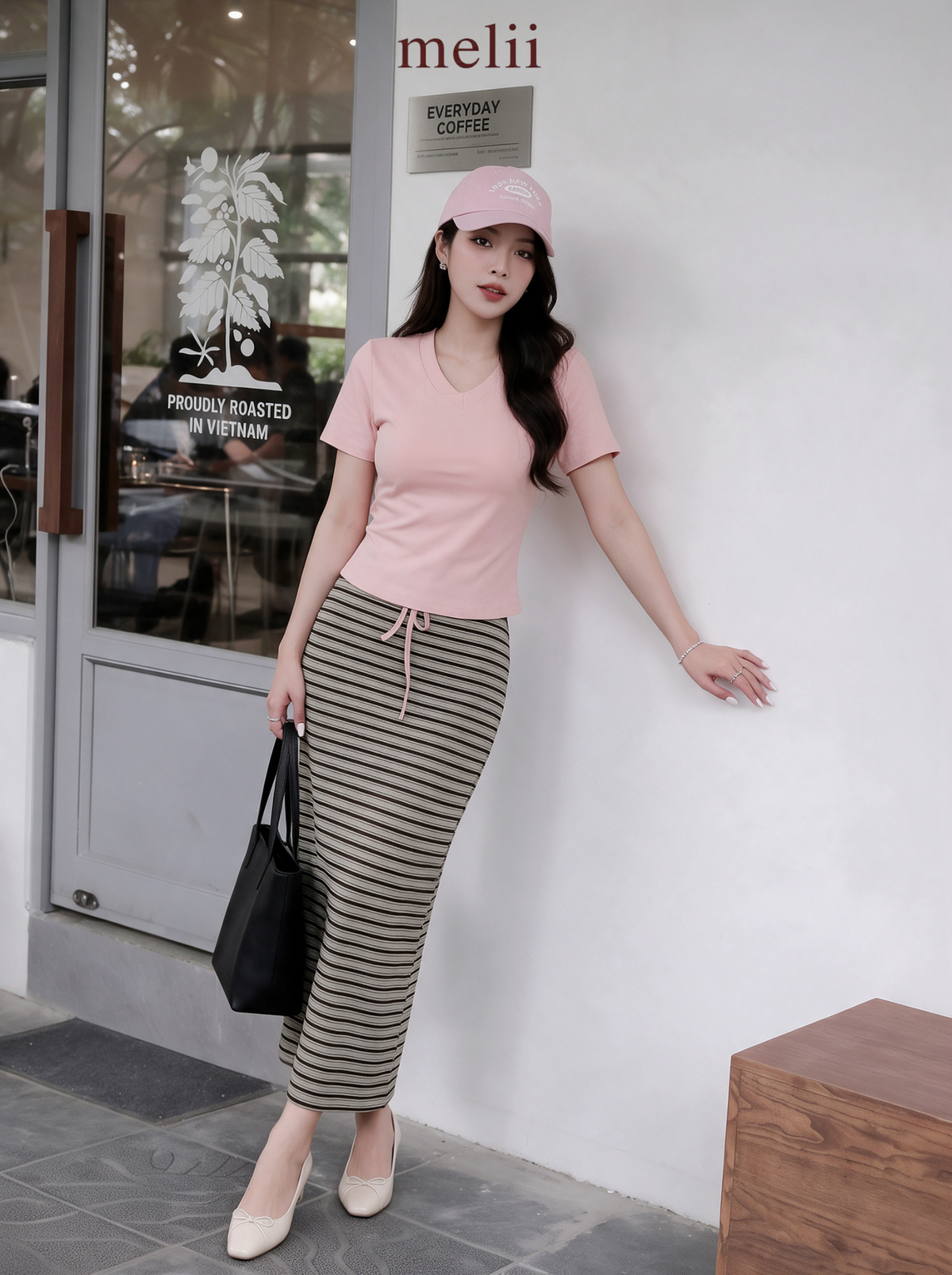 MELII Mira Blush Pink V-Neck Top and Striped Maxi Skirt Set, on-model view outside a cafe