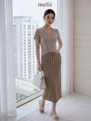 MELII Mira V-Neck Drawstring Top and Striped Maxi Skirt Set in Beige, full-length angled model view with a white handbag