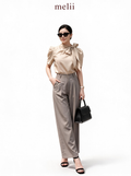 MELII warm beige bow-neck blouse with charcoal-grey wide-leg trousers, studio model view