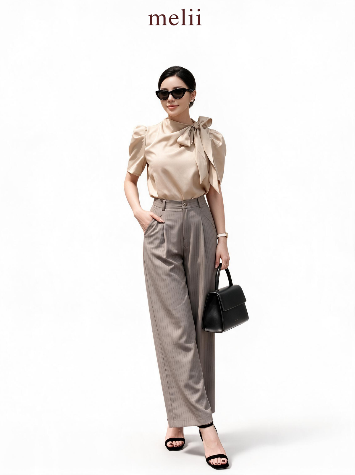 MELII warm beige bow-neck blouse with charcoal-grey wide-leg trousers, studio model view
