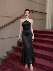 Premium Bodycon Halter Dress in Black, full-length front view on staircase